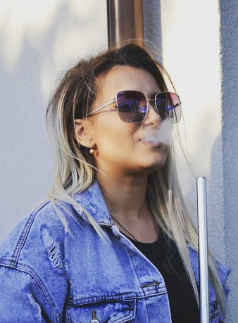 iLo in a denim jacket and sunglasses
